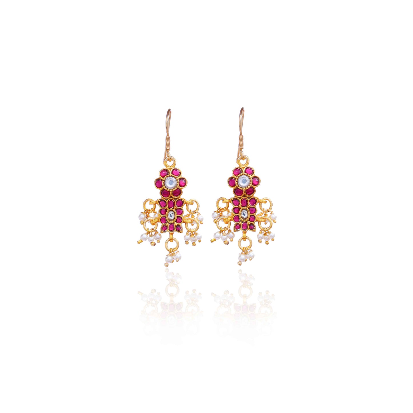 A close-up image of a woman's ear adorned with a gold-toned Kundan earring featuring pink and white gemstones in a floral design, with small pearl dangles adding movement and elegance.
