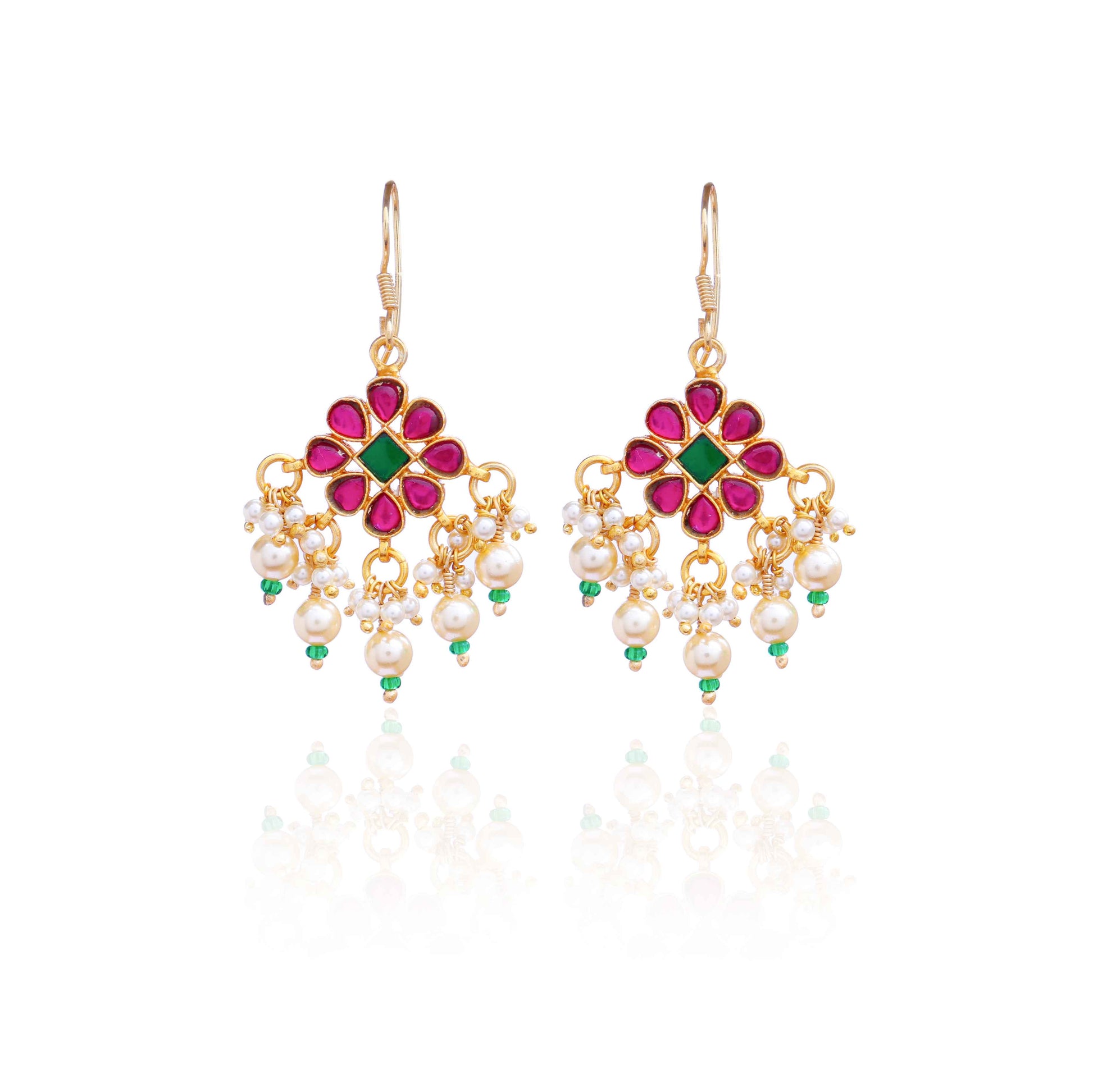 Gold-plated floral chandelier earrings with red and green gemstones, pearl drop accents, and intricate detailing, perfect for ethnic and festive wear.
