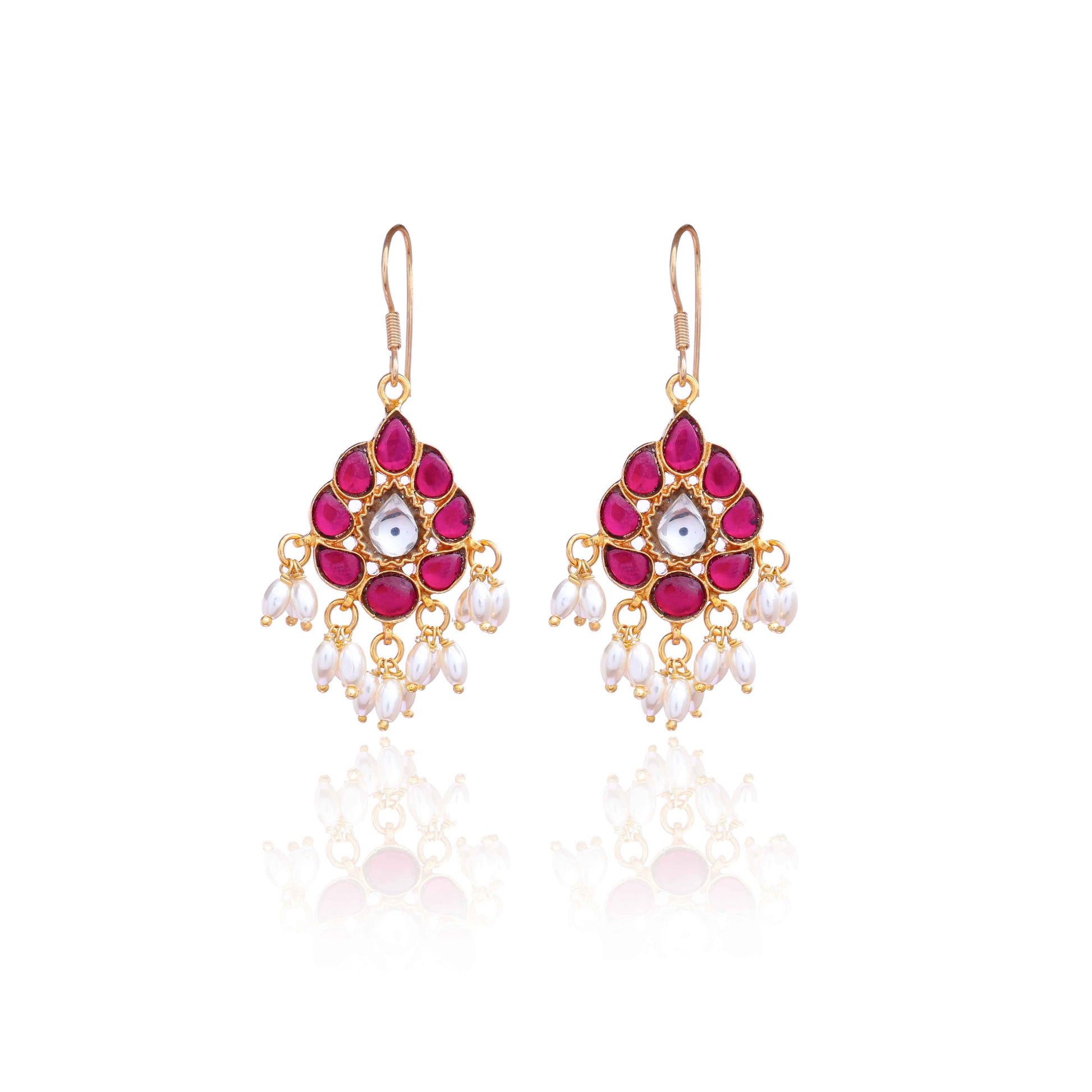 A close-up image of a woman's ear wearing a teardrop-shaped gold-toned drop earring, adorned with deep pink gemstones, a central white stone, and dangling white pearl-like beads.