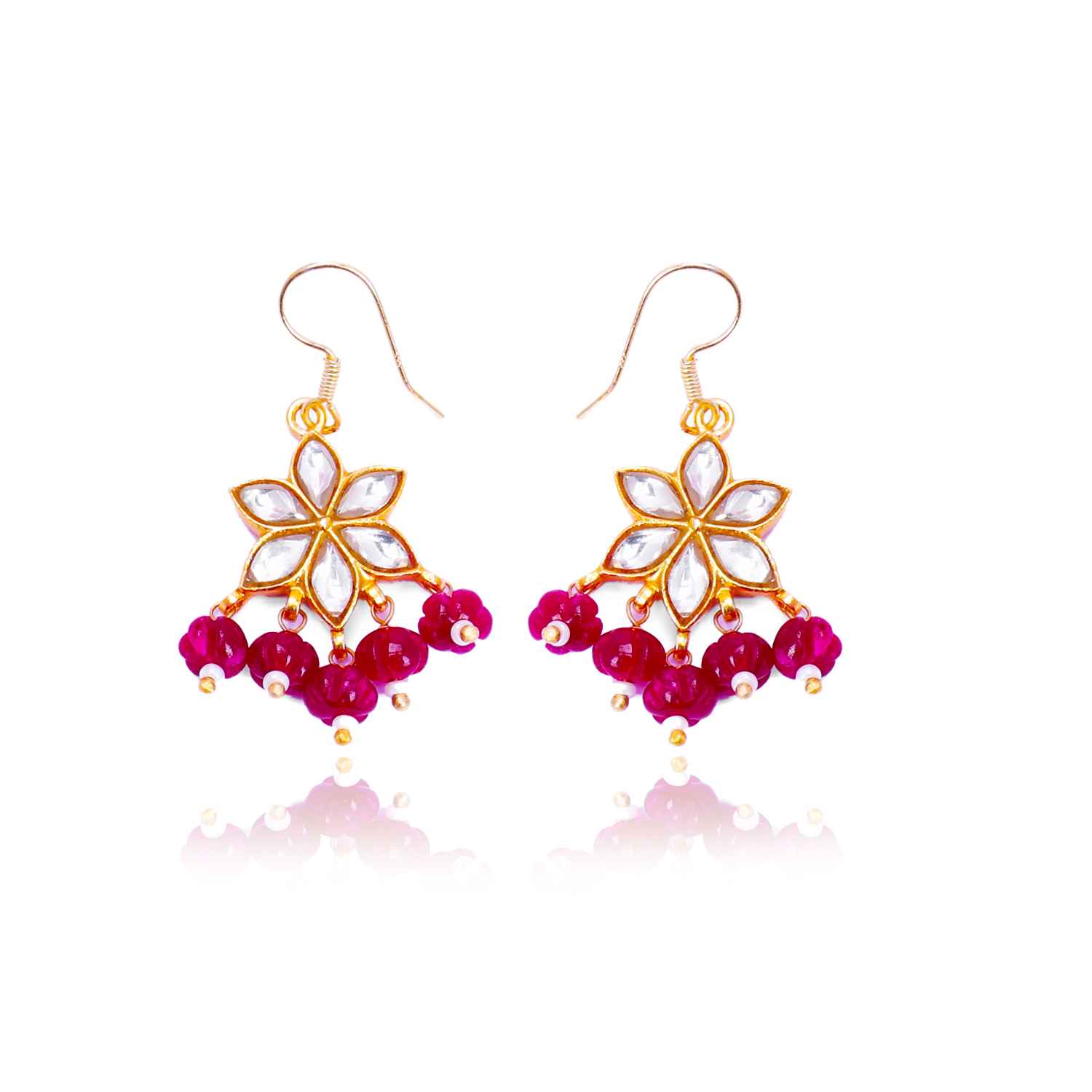Gold-plated floral Kundan earrings featuring a six-petal design with clear gemstones and dangling red beads, elegantly worn by a model.
